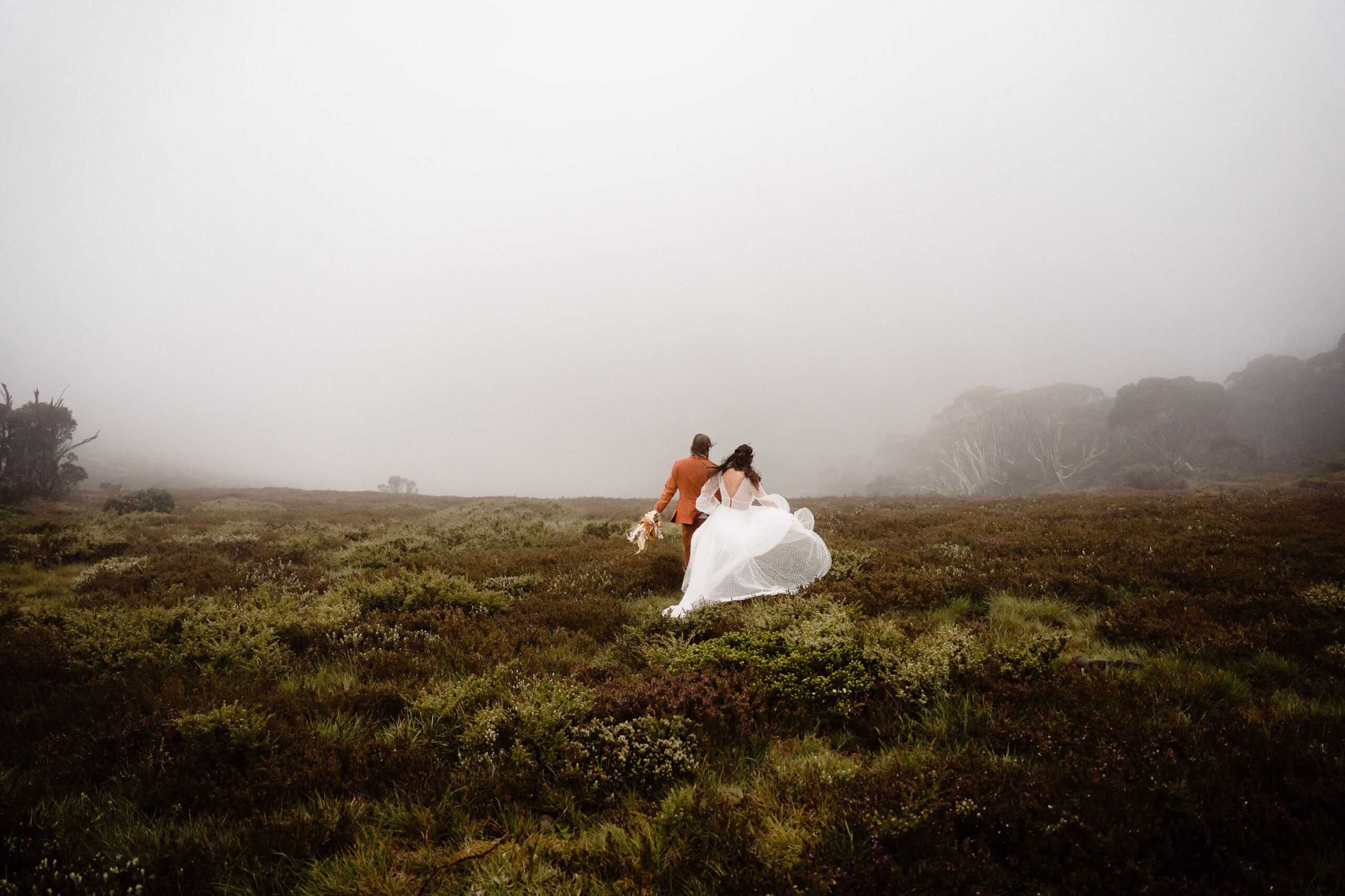 Xmina and Ben's winter elopement in Australia. The couple climb a mountain on their elopement day.